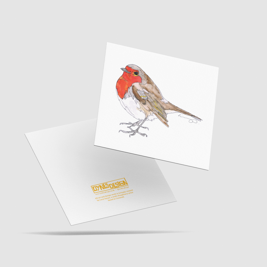 A square white art print card featuring a watercolor-style robin bird with a bright red breast, shown floating above the back image which has the logo mark "DYNES DESIGN", all on a light gray background.