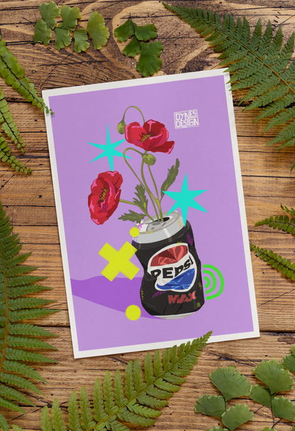 An art print with a white border, featuring a purple background and an illustration of red poppies growing from a black Pepsi Max can, styled flat-lay on a rustic wooden surface surrounded by green ferns. The artist's brand 'Dynes Design' is visible in the top right corner of the print.