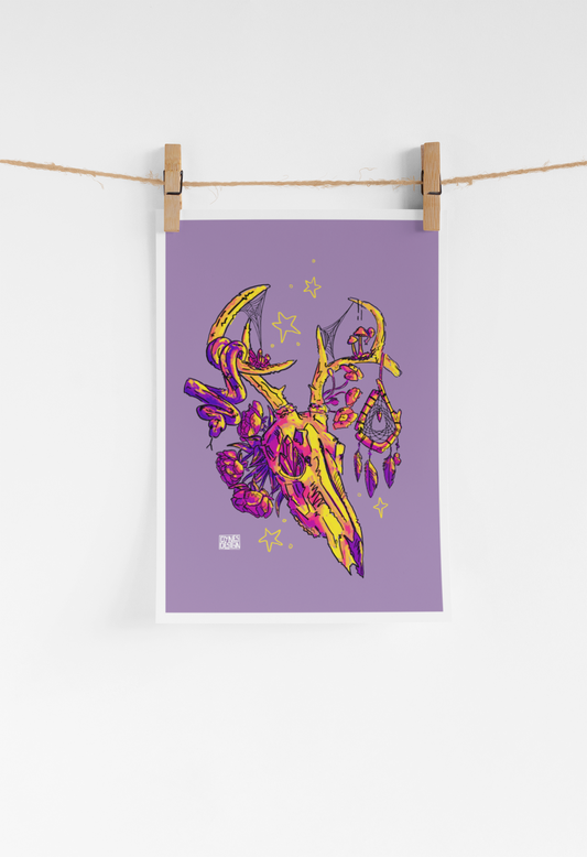 A vertical art print with a lavender-purple background featuring a stylized yellow and magenta deer skull illustration, hanging from a string with two wooden clothespins against a white wall.