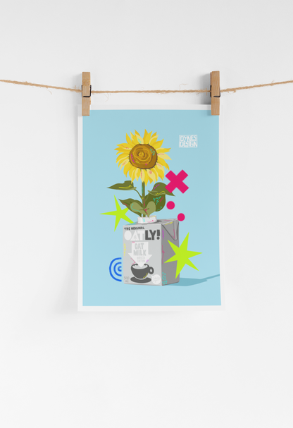 A vertical art print featuring a stylized sunflower in an oat milk carton with colorful star and dot accents on a light blue background, hanging from a string with wooden clothespins against a white wall.