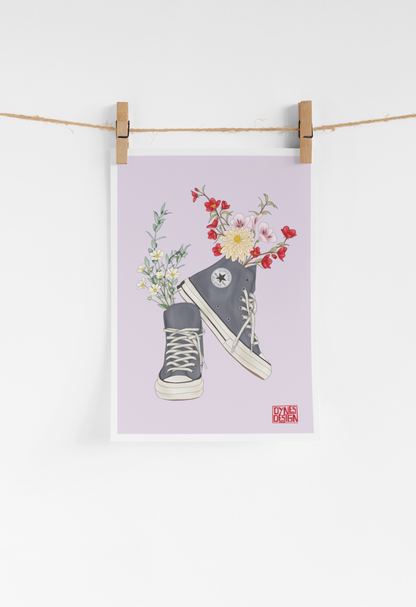 Poster of a sneaker with flowers on a purple background, hanging on a clothesline.