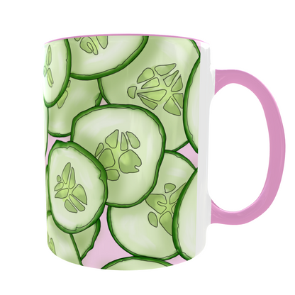 Mug with cucumber slice pattern and pink handle on a white background